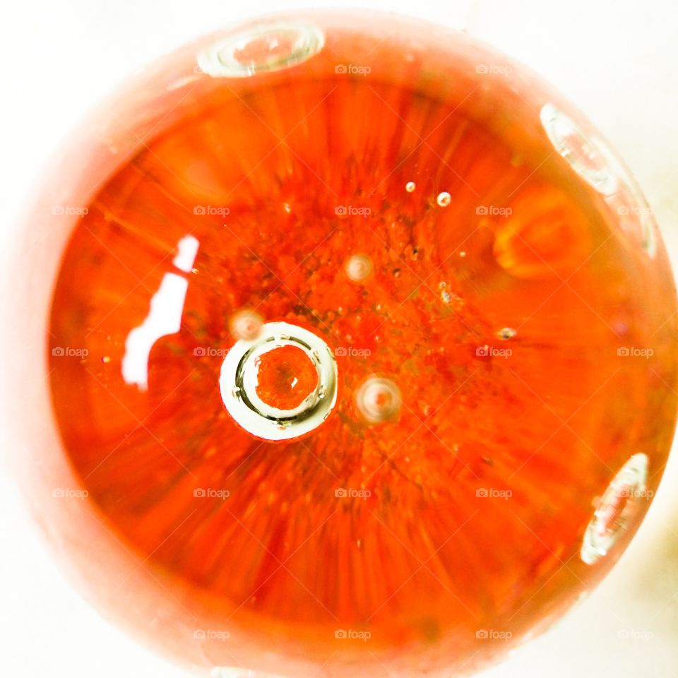 Abstract image of glass paperweight with orange accent