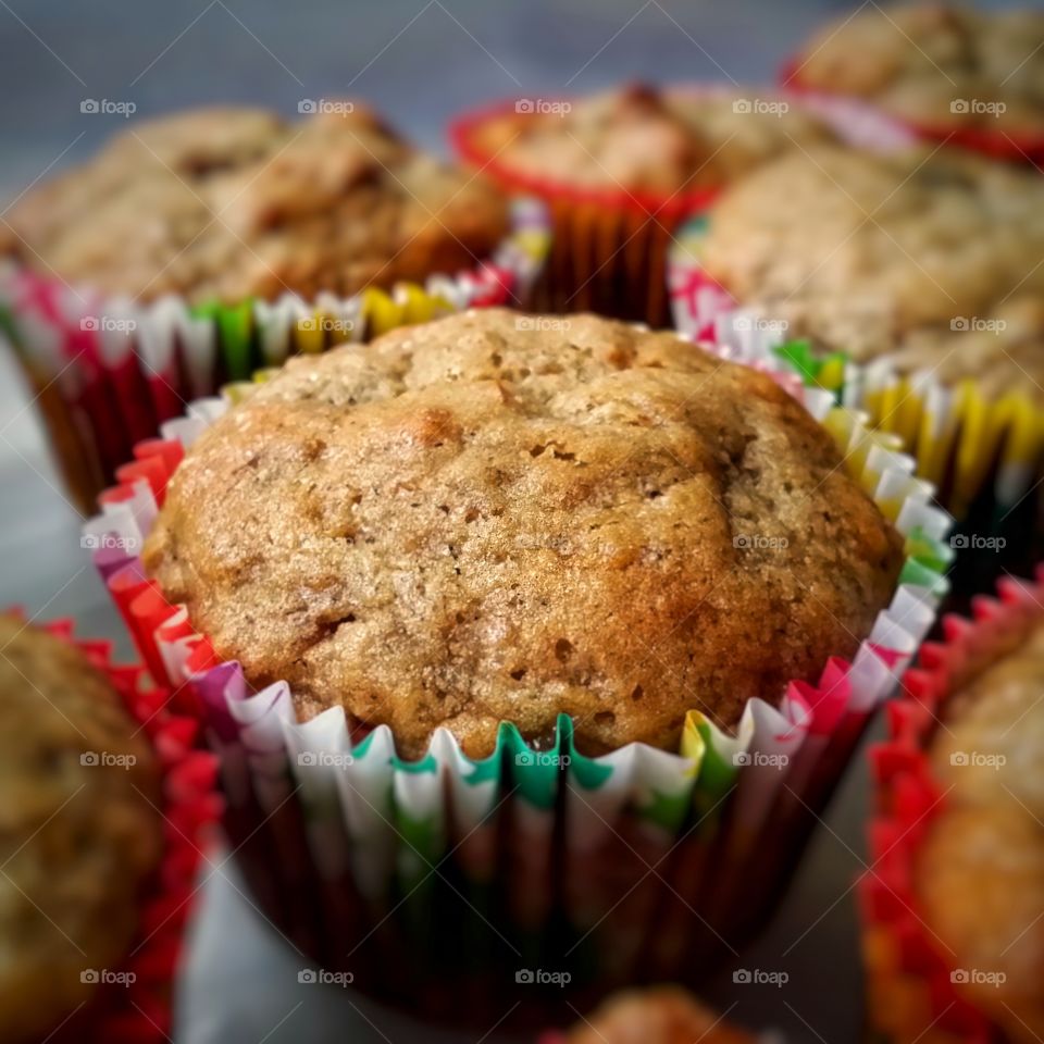 Homemade fresh banana nut muffins in spring colored cupcake paper liners