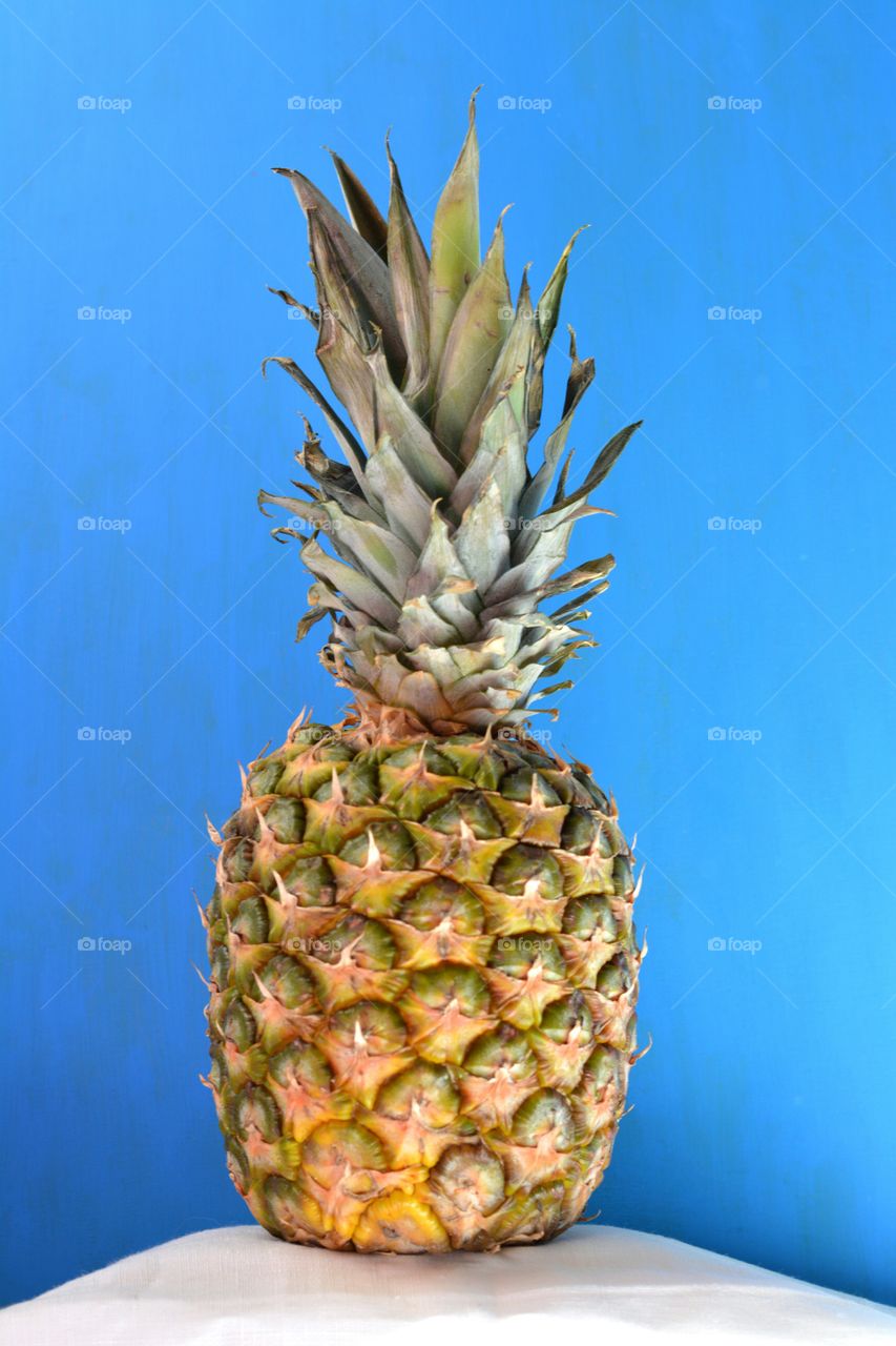 fresh pineapple fruit blue background