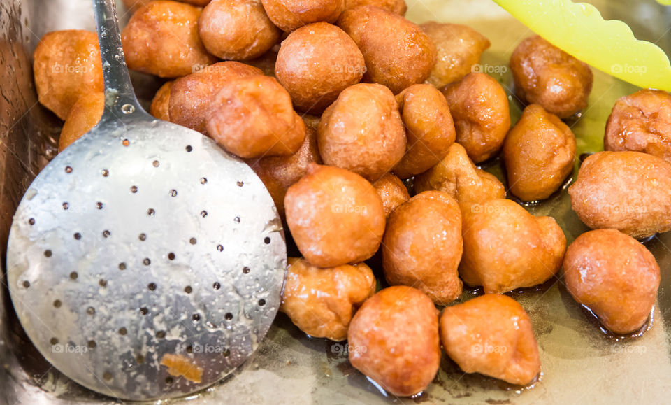 Greek Loukoumades Donuts With Honey, And Metal Skimmer
