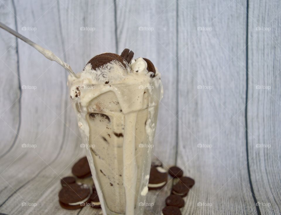Oreo cookie milkshake with a wooden rustic white background