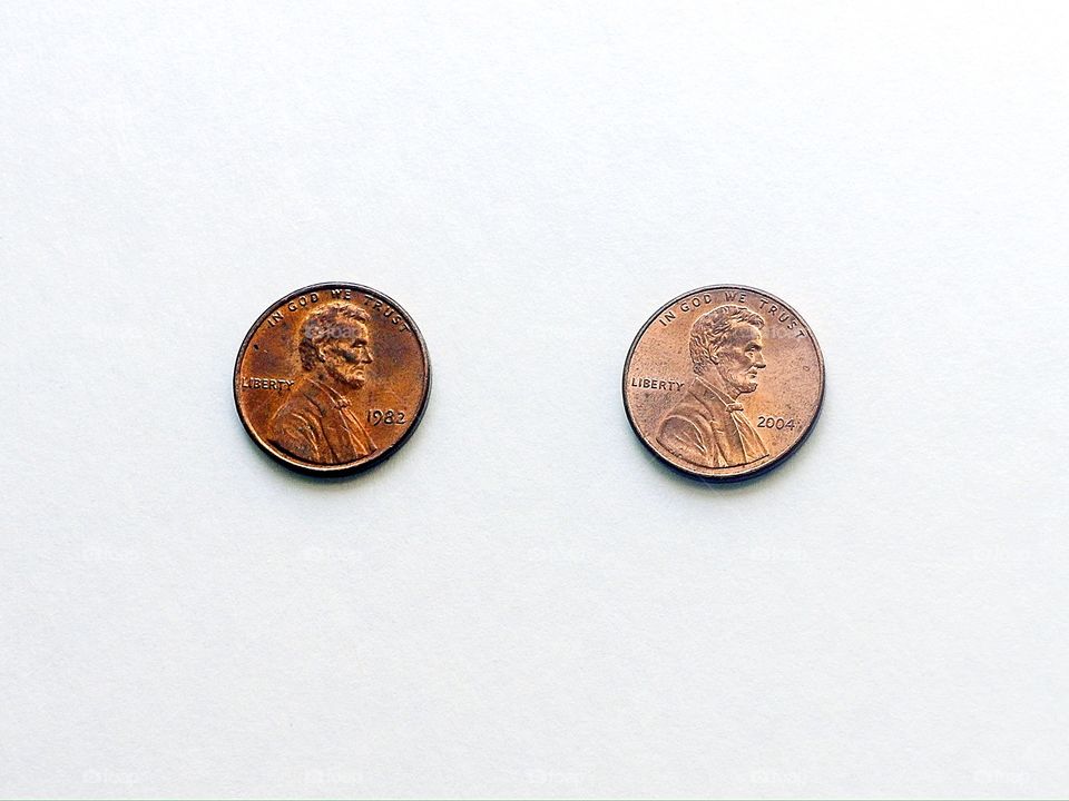 Closeup of Two pennies on a white background 