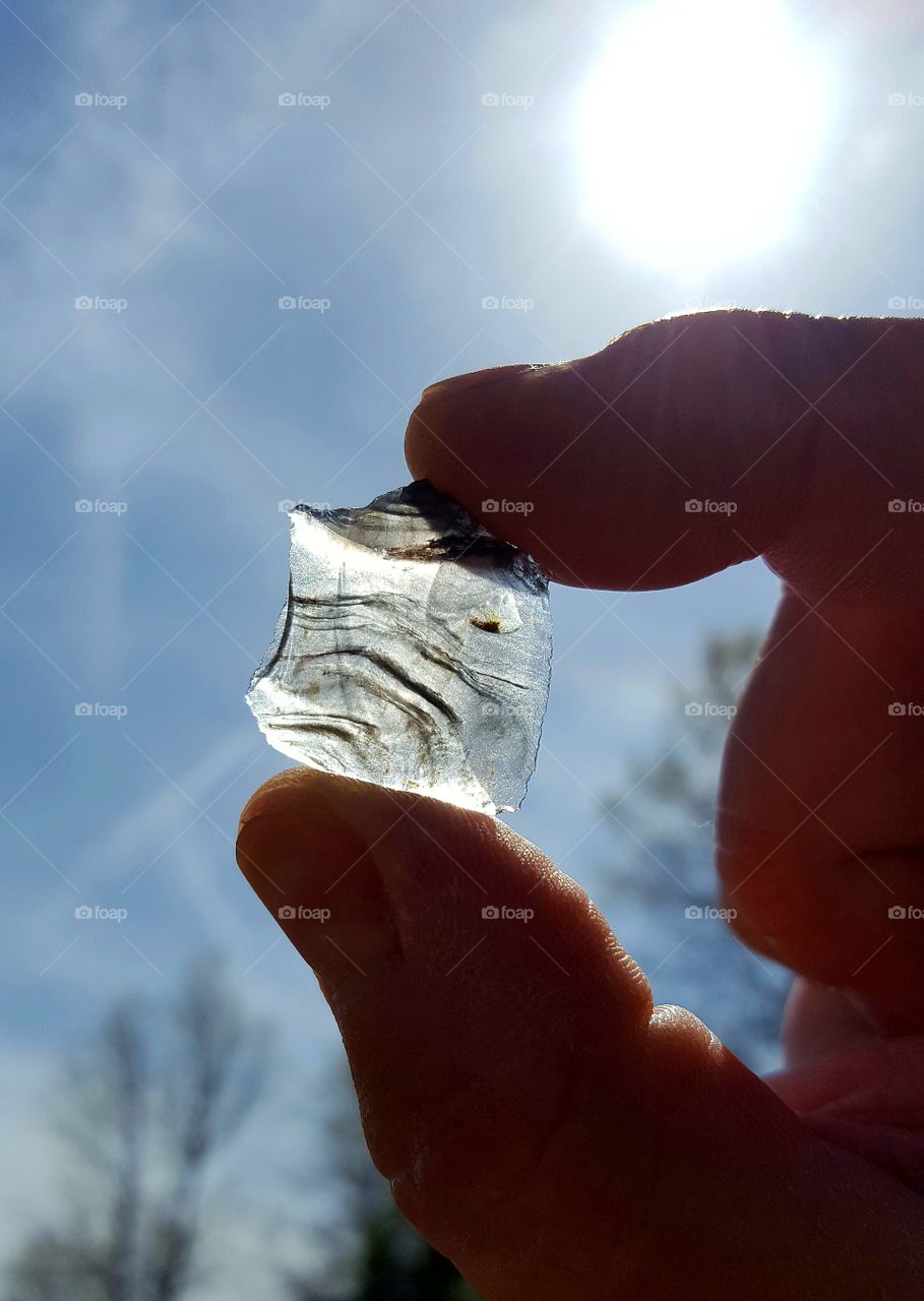 A very thin piece of obsidian up against the light of the sun.