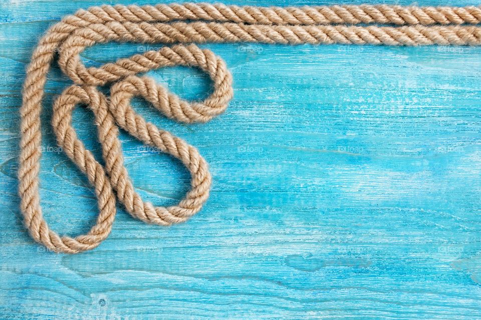 A pattern of a rope on a blue wooden background.