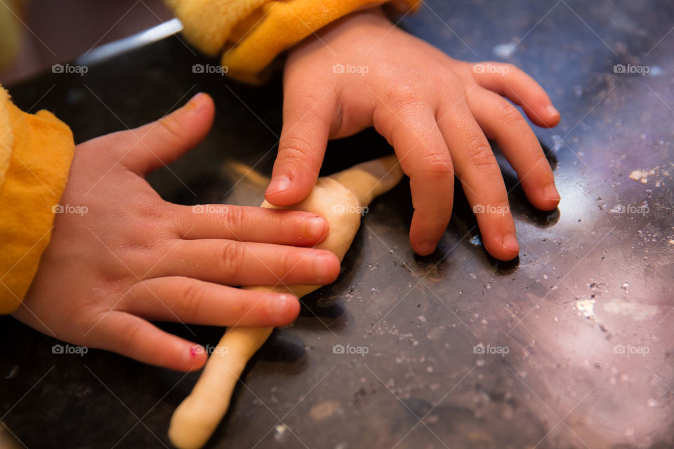 Close-up of a child kneading dough