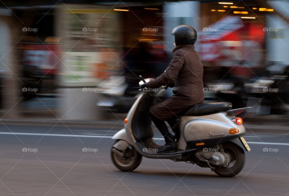 Woman on Vespa scooter.