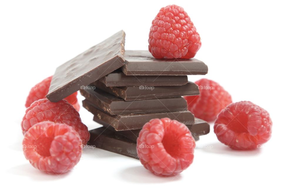 Pieces of chocolate and raspberries