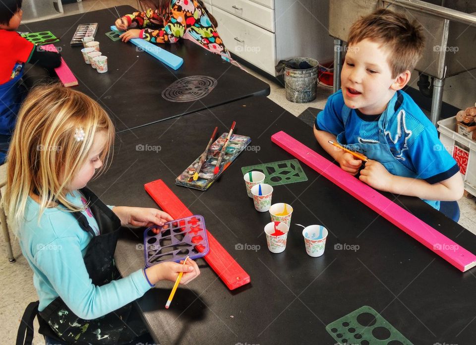 Elementary School Students Making A Classroom Art Project
