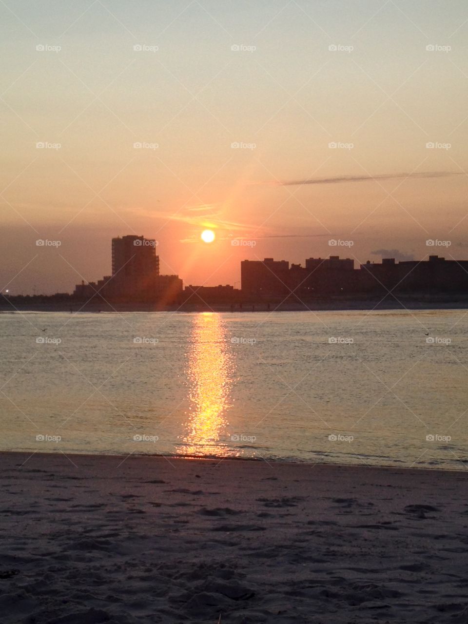 Orange ball sunset over the bay