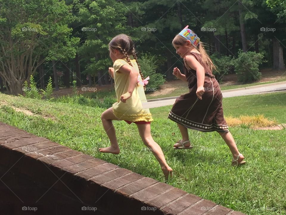 Girls running up a hill
