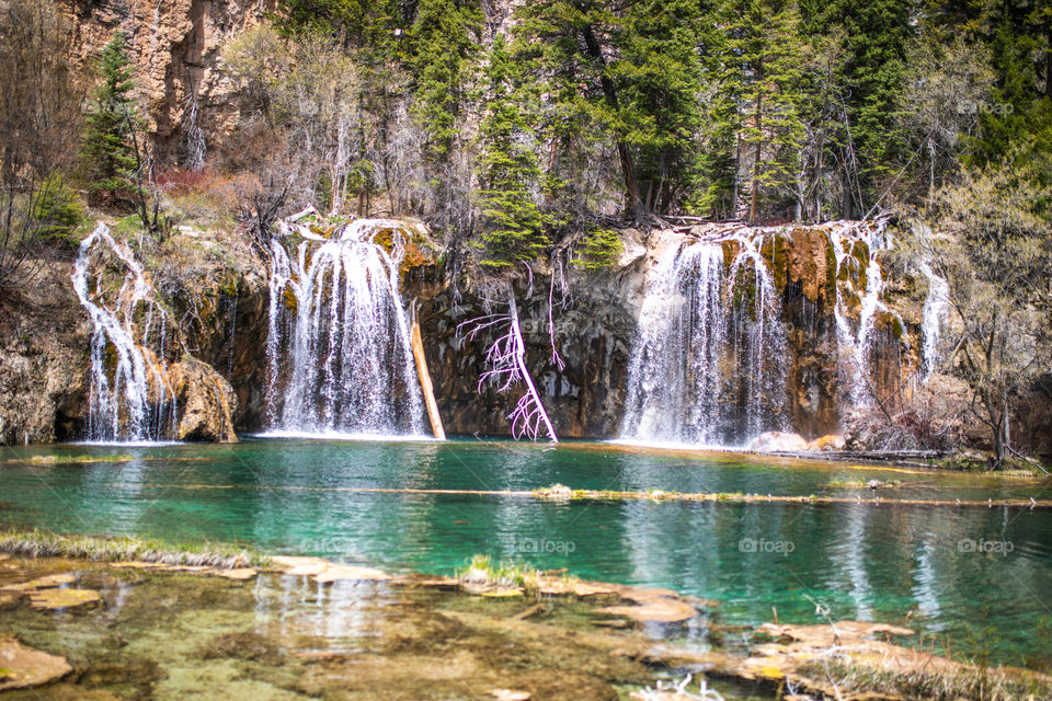 Beautiful crystal clear water flowing from a waterfall into a Colorado lake high in the mountains. 