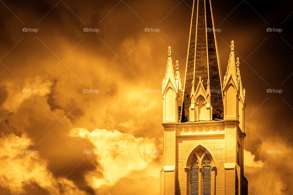 Storm brewing near historic church building.  
