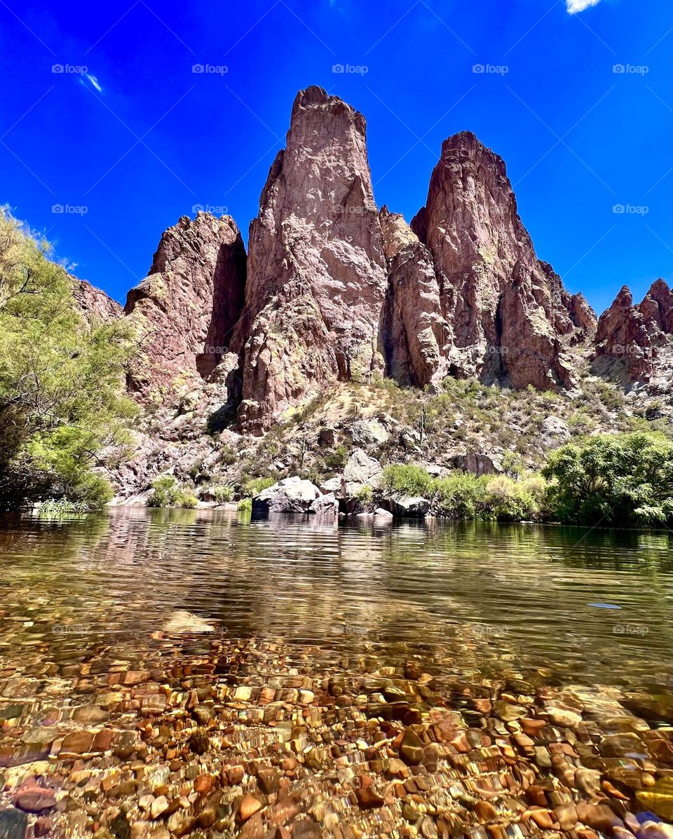 The soaring rock formations along the salt river in Mesa Arizona, beautiful wildlife all around, wild horses walking along side the river as beautiful herrings fly right above you. The clearest of waters shows the beautiful coloring of all the rocks.