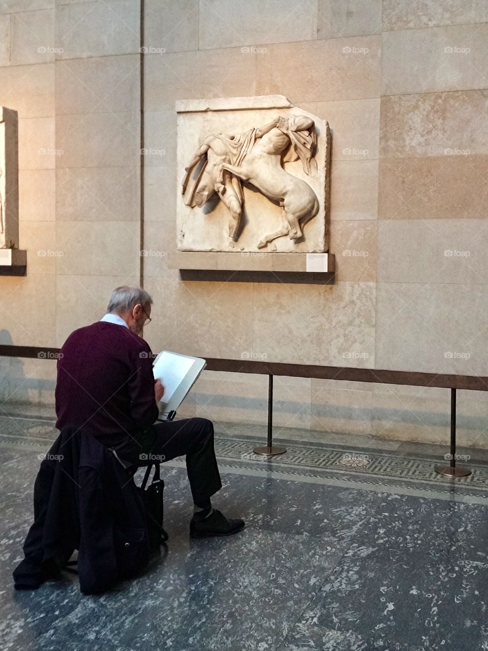 An artist paints a painting in the British Museum
