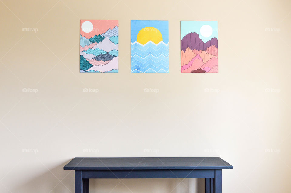 Graphic wall art displayed above a table