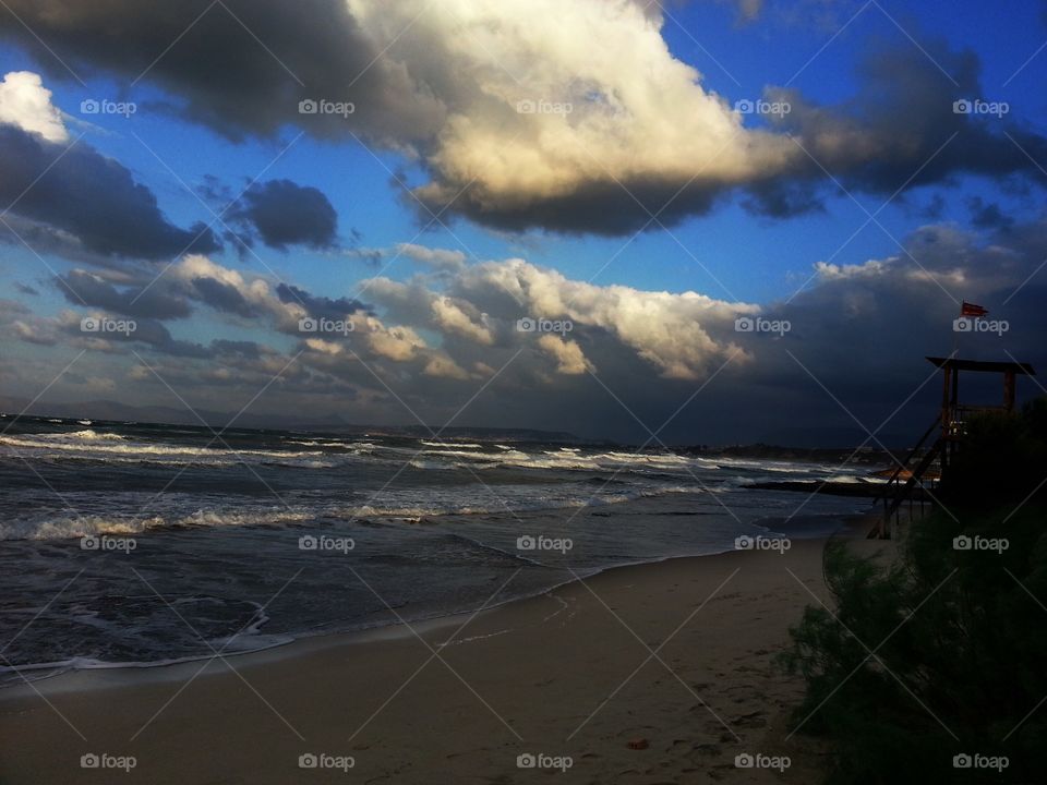 Scenic view of beach against cloudscape