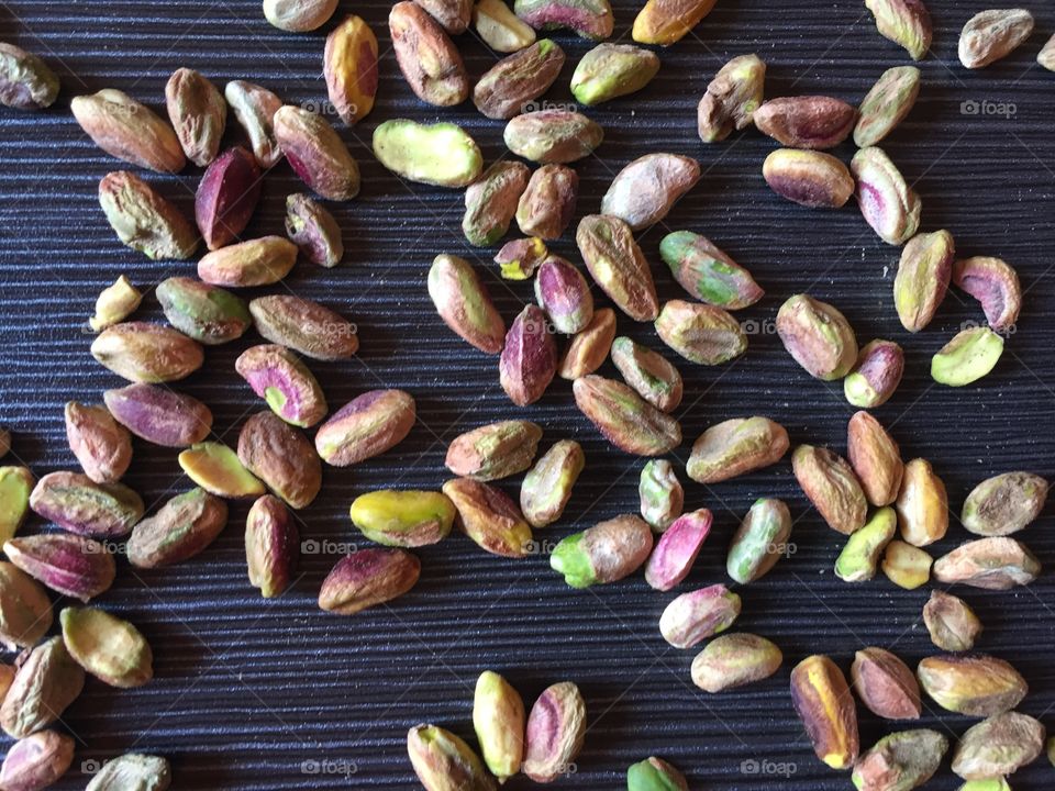 Pistachio on grey wooden background 