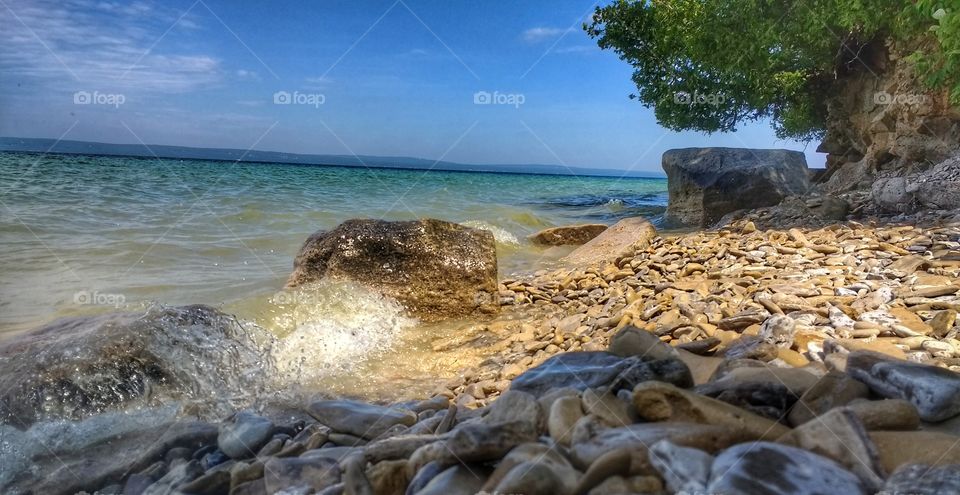 Stoney beach with turquoise water