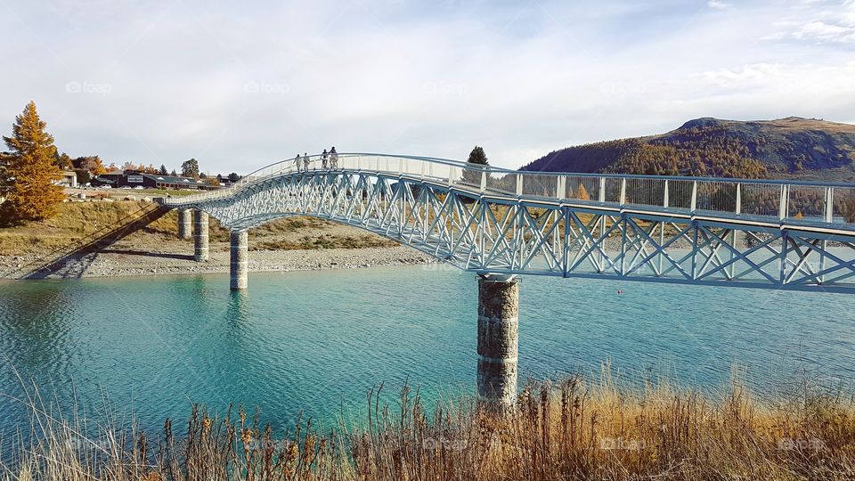 Enchanting bridge over Lake Tekapo's turquoise water