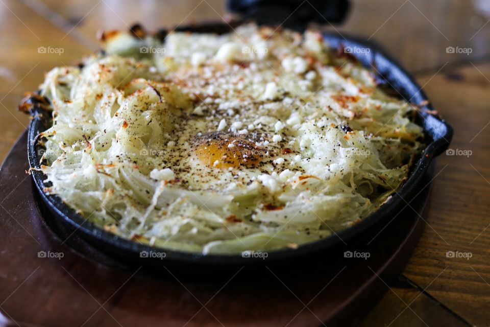 Brunch. Homemade skillet fried shredded potatoes, onions, and garlic with eggs. Than baked and sprinkled with cayenne pepper and pecorino cheese. Always lightly salted.