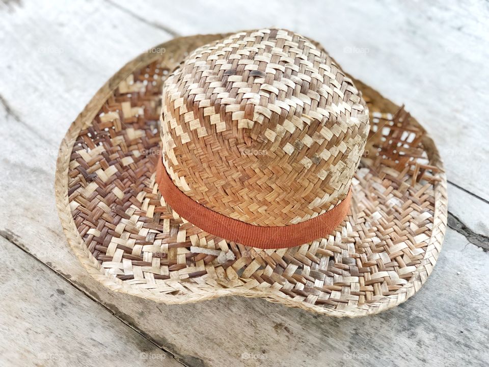 Lovely summer hat on retro wooden texture floor for copy space 