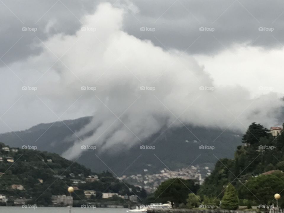 Clouds roll in over the mountain at Lake Como, Italy 