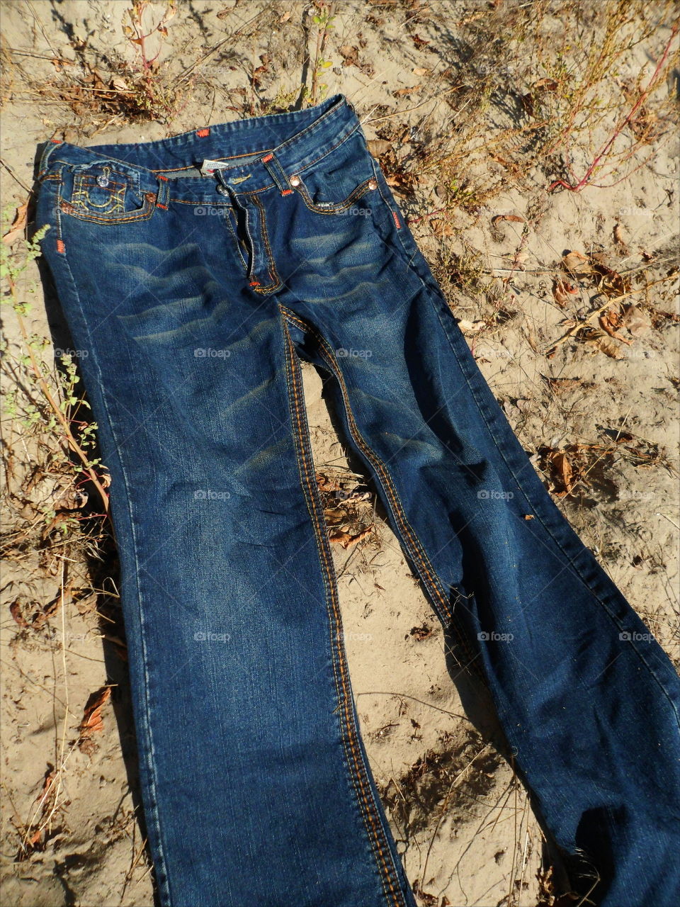 jeans lie on sand