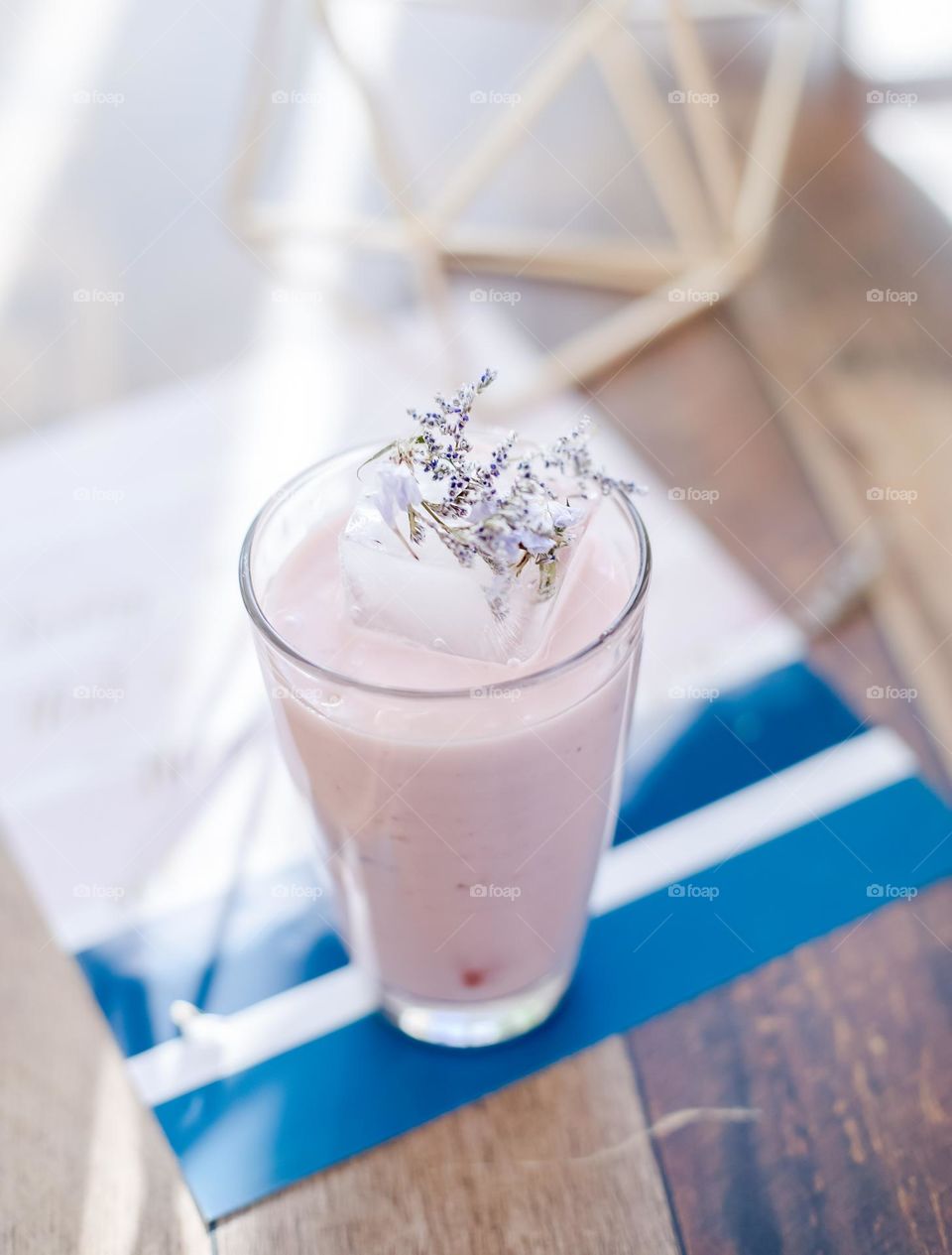 Pink Drink With A Large Ice Cubes And Flowers