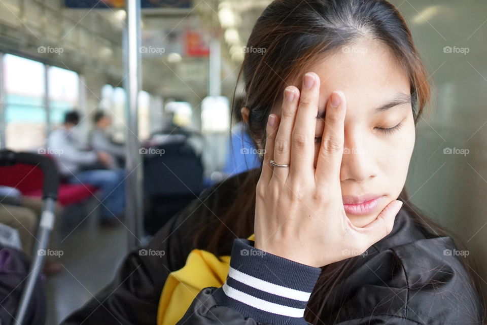 Japanese girl having motion sick on a train