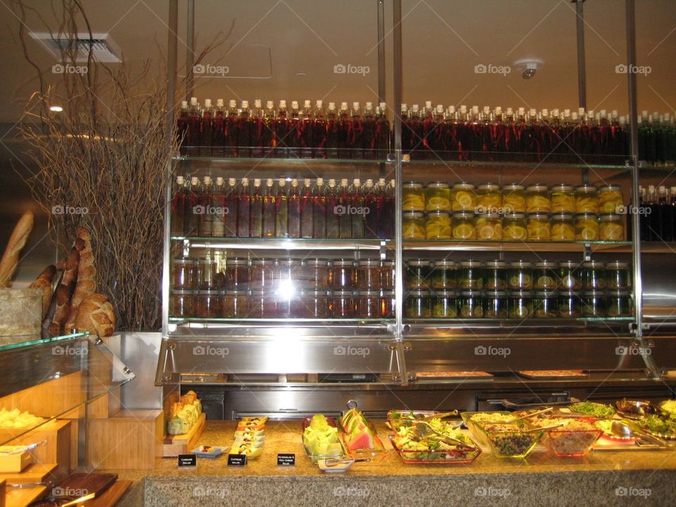 Jars and bottles of pickles. Bread, salad bar and wall of pickles.