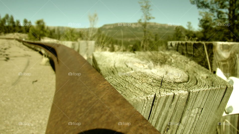 Wooden post with mountains in background 