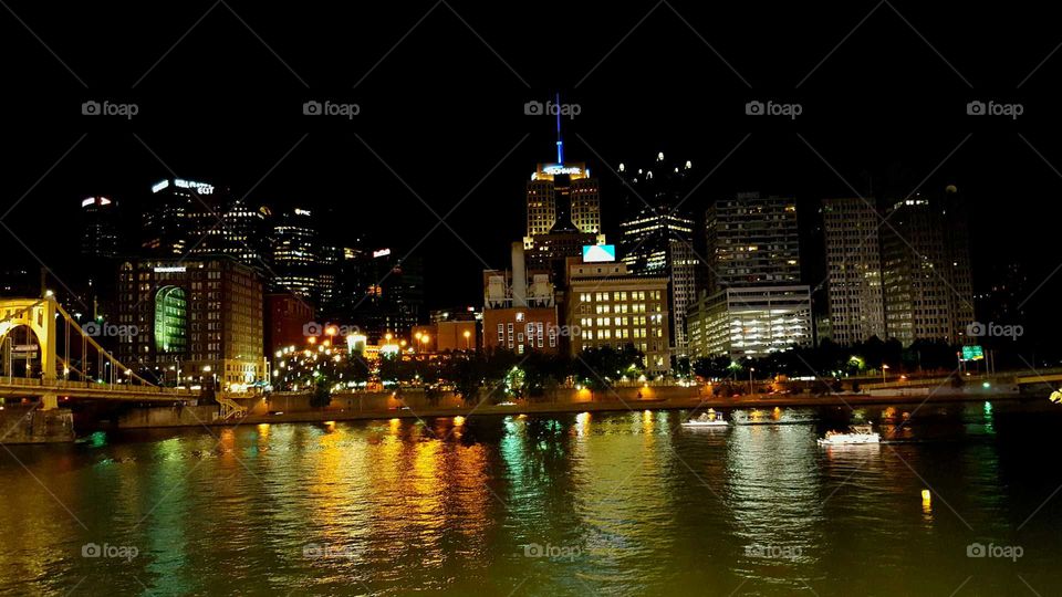 City lights reflect off the rivers to give a colorful glow at night.