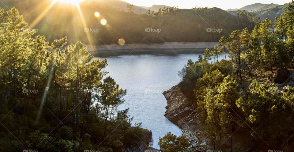 The sun sets over the mountains and Rio Zêzere in Central Portugal 