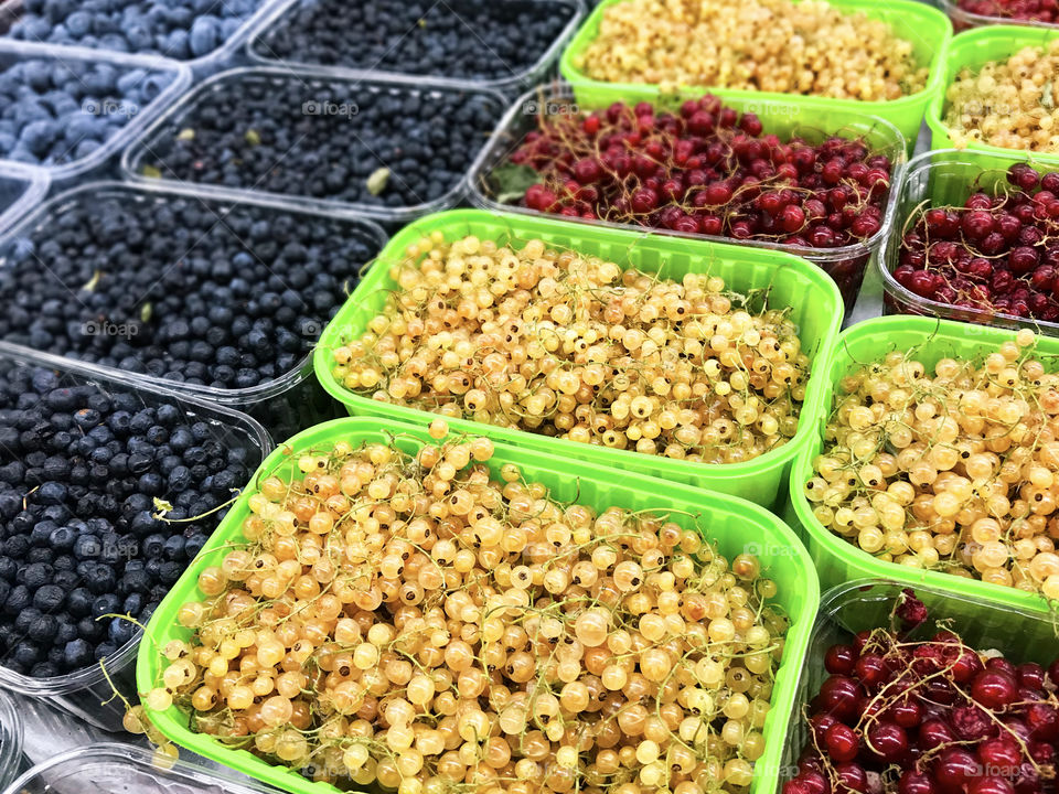 Many different colorful summer ripe berries- white currants, red currants, blackberries, blueberries 