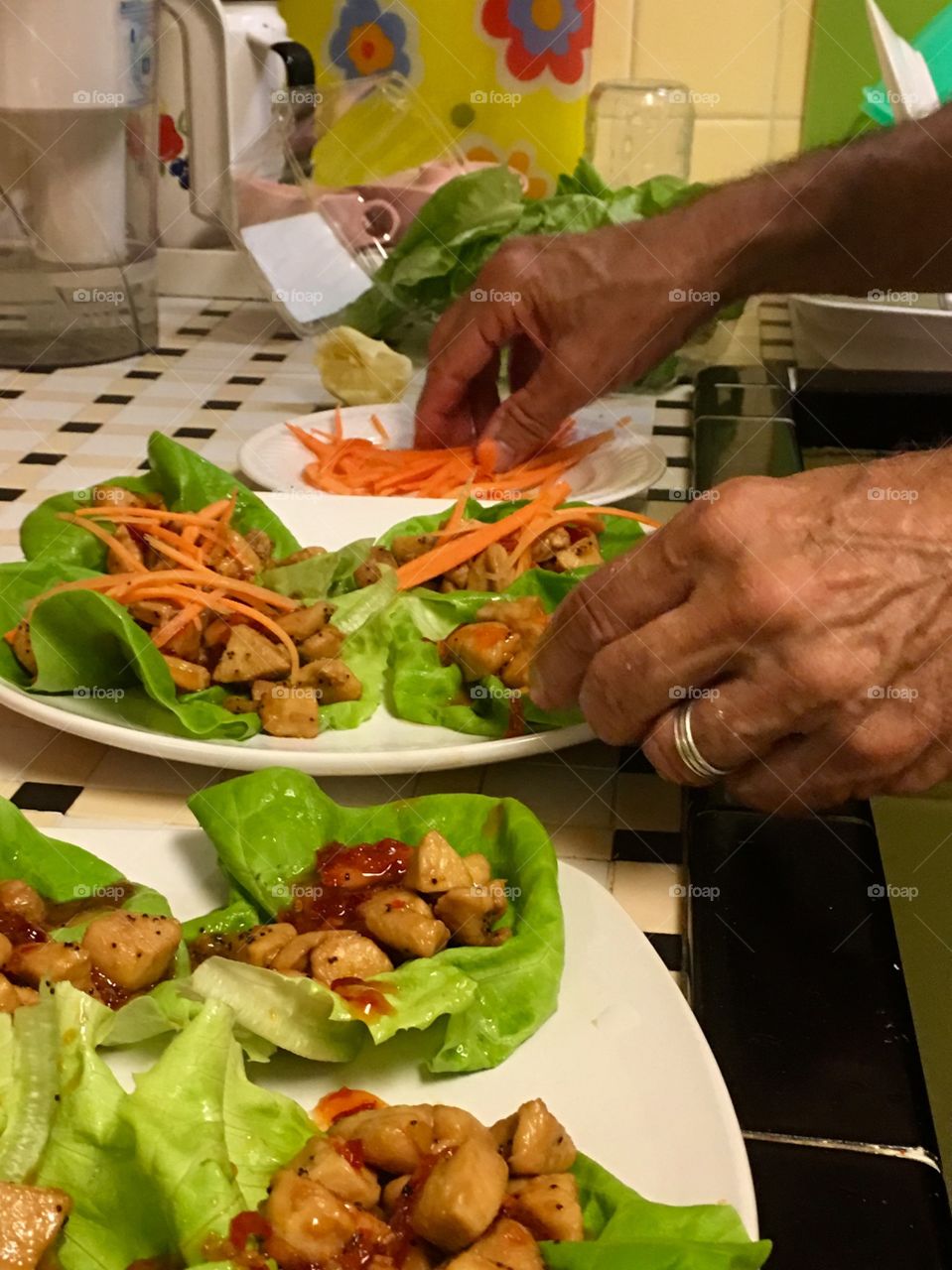 Working hands preparing Asian lettuce wraps. 