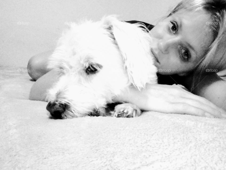 young woman posing with her small dog, a white terrier