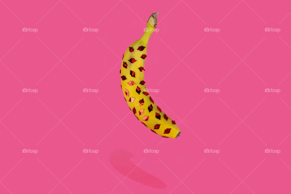 Floating banana with red lips. Creative love concept