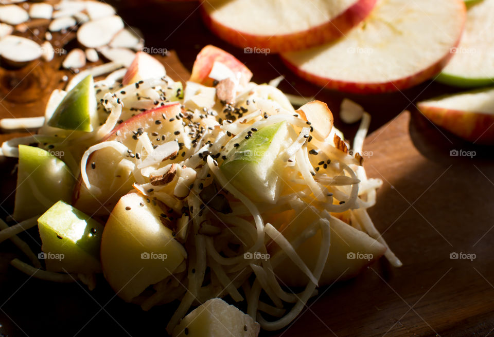 Fresh summer apple and celery root salad with chia seed and    Almond nuts healthy refreshing salad rich in nutrients gourmet food photography variation in classic Waldorf salad 