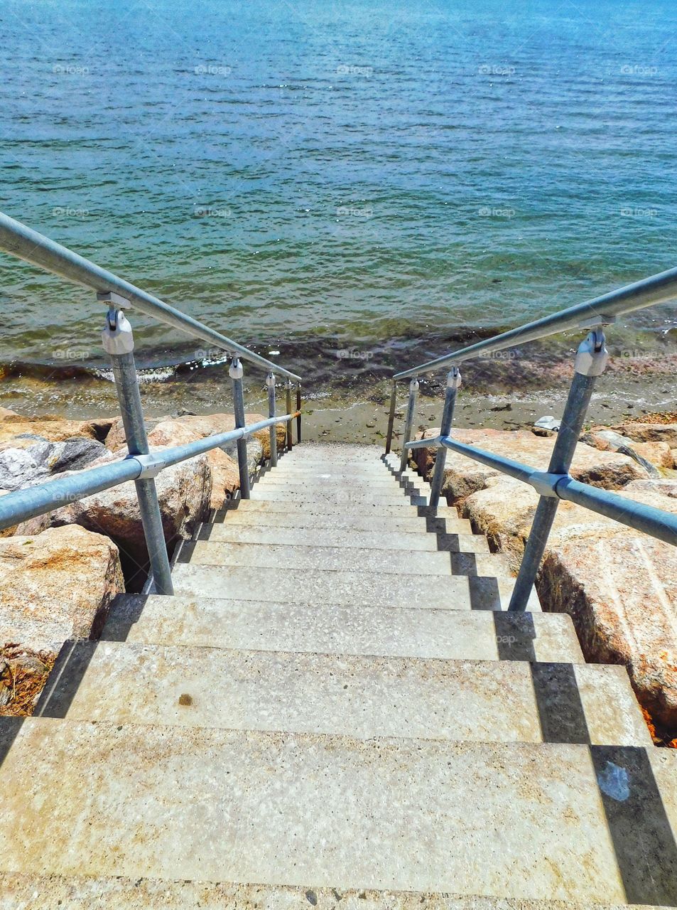 Steps down to the bottom of the seawall and the tiny private beach...