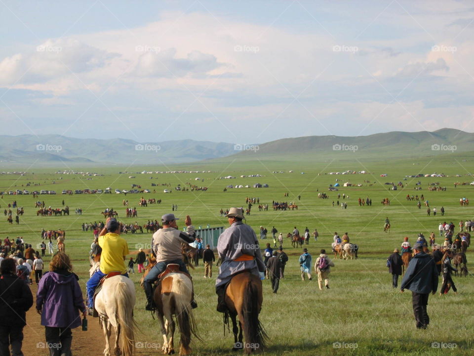 Horse festival in Mongolia. Every july children compete in horse racing and many families travels for weeks to get there. Some have sadles some don't. 