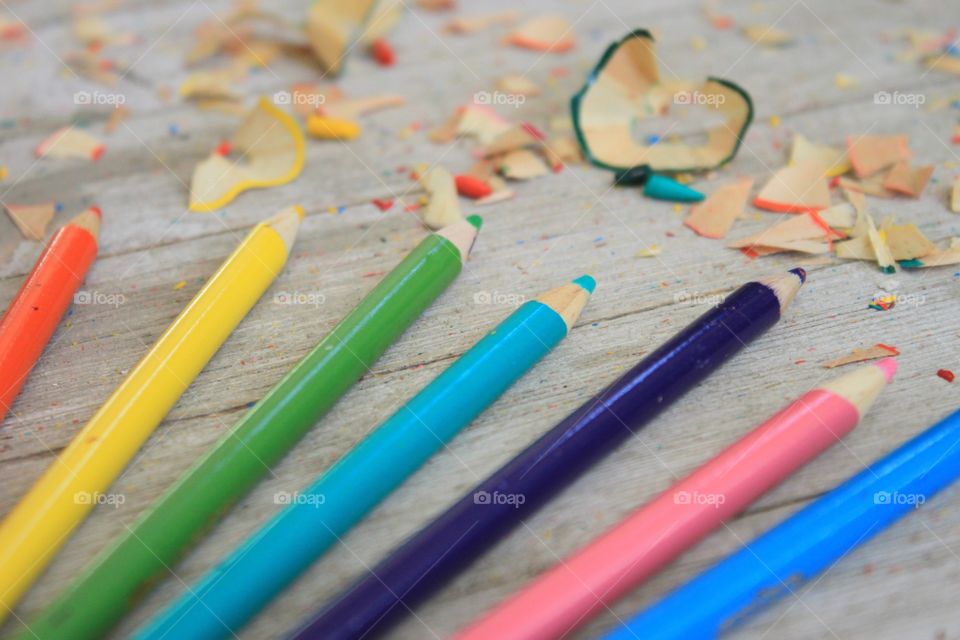 Various colored pencils on wood