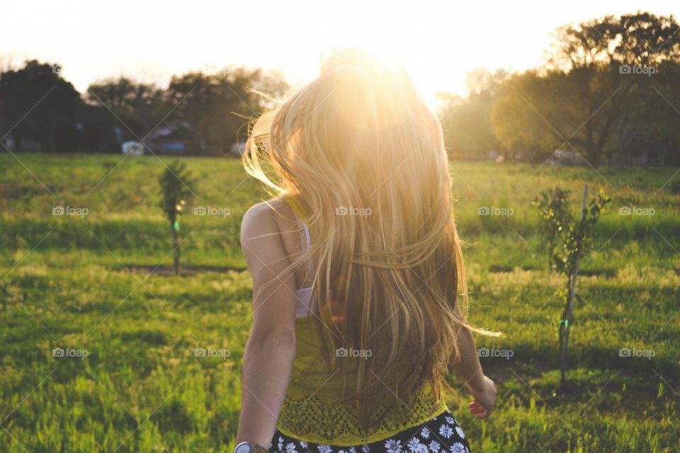 Girl running in grass, sunsets view there's a beauty in nature.