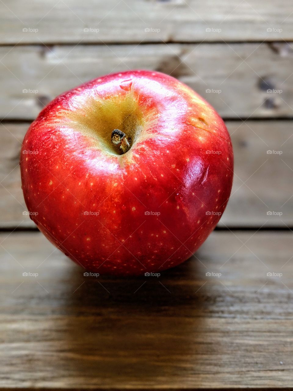 A red apple on a wooden background