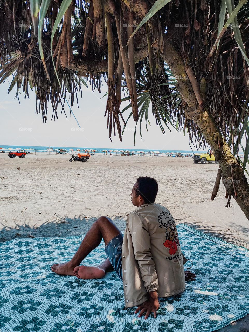 man sitting on the beach.