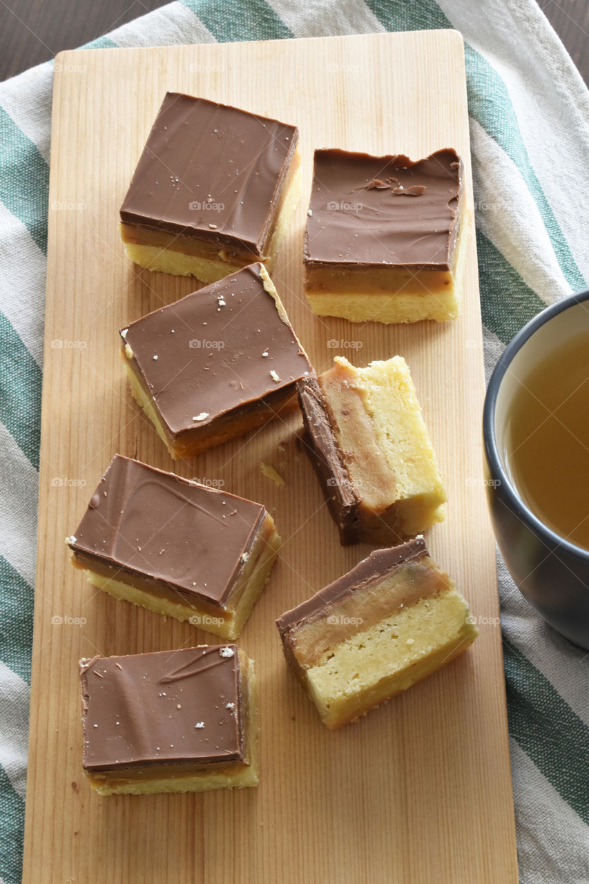 Millionaire's shortbread, caramel shortcake, or millionaire's slice on a chopping board.