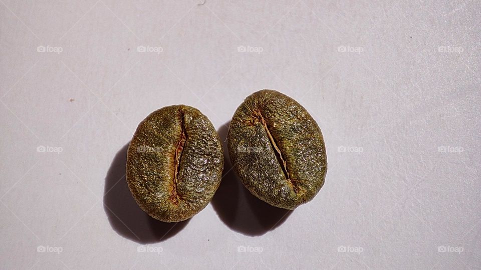 macro image of golden colour Coffee beans on a white surface