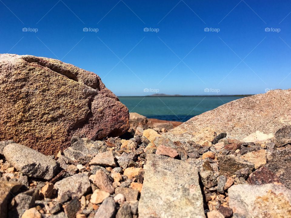 Peekaboo ocean view from
Behind rock formation, scenic vista horizon 