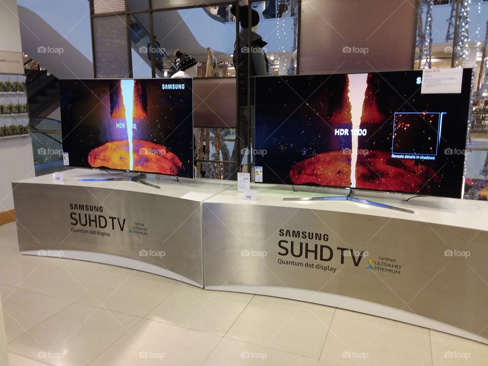 Samsung QLED televisions 4K UHD TV displayed on stainless steel plinths at Peter Jones