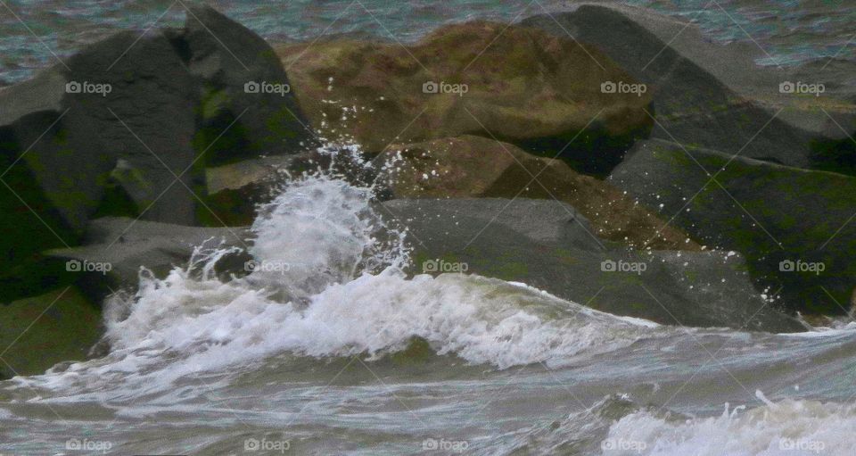 Waves breaking over the rocks