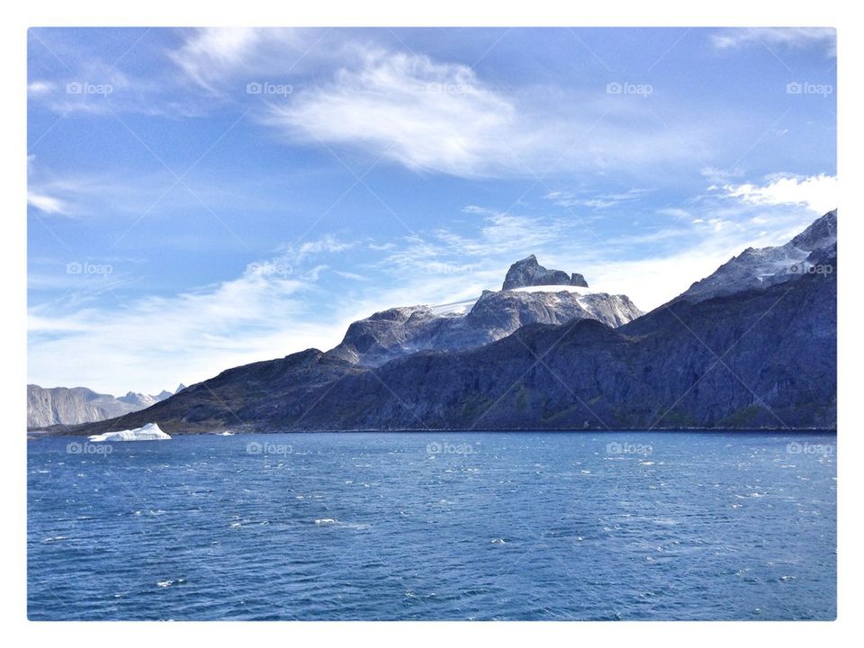 Greenland mountains and iceberg